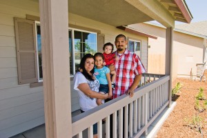 Self-Help Enterprises_de la Rosa family standing in front of the new home they built in Corcoran 2012